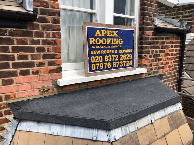 Repaired bay roof with new dark slate finish and leadwork around the edges.