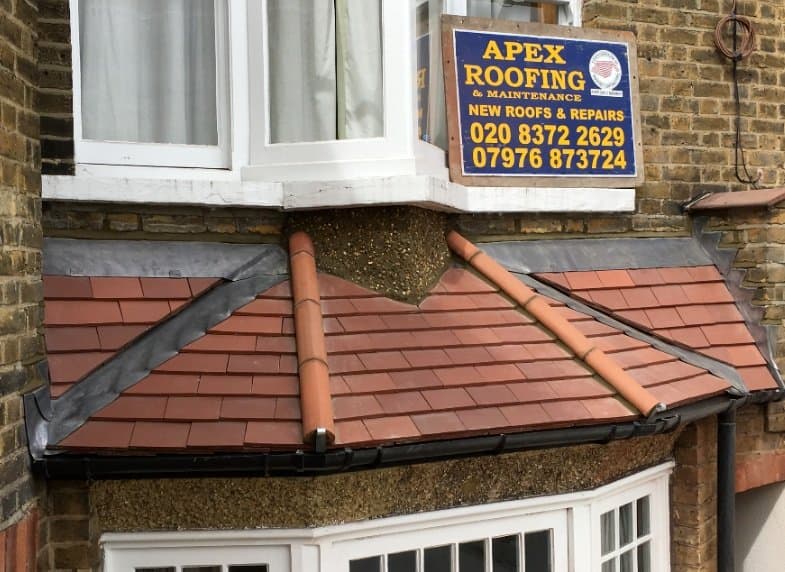 Restored tiled bay roof with matching ridge details