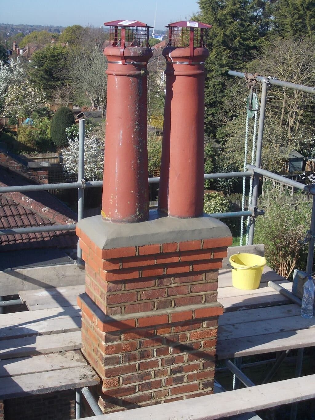 Rebuilt brick chimney with new pots and crown