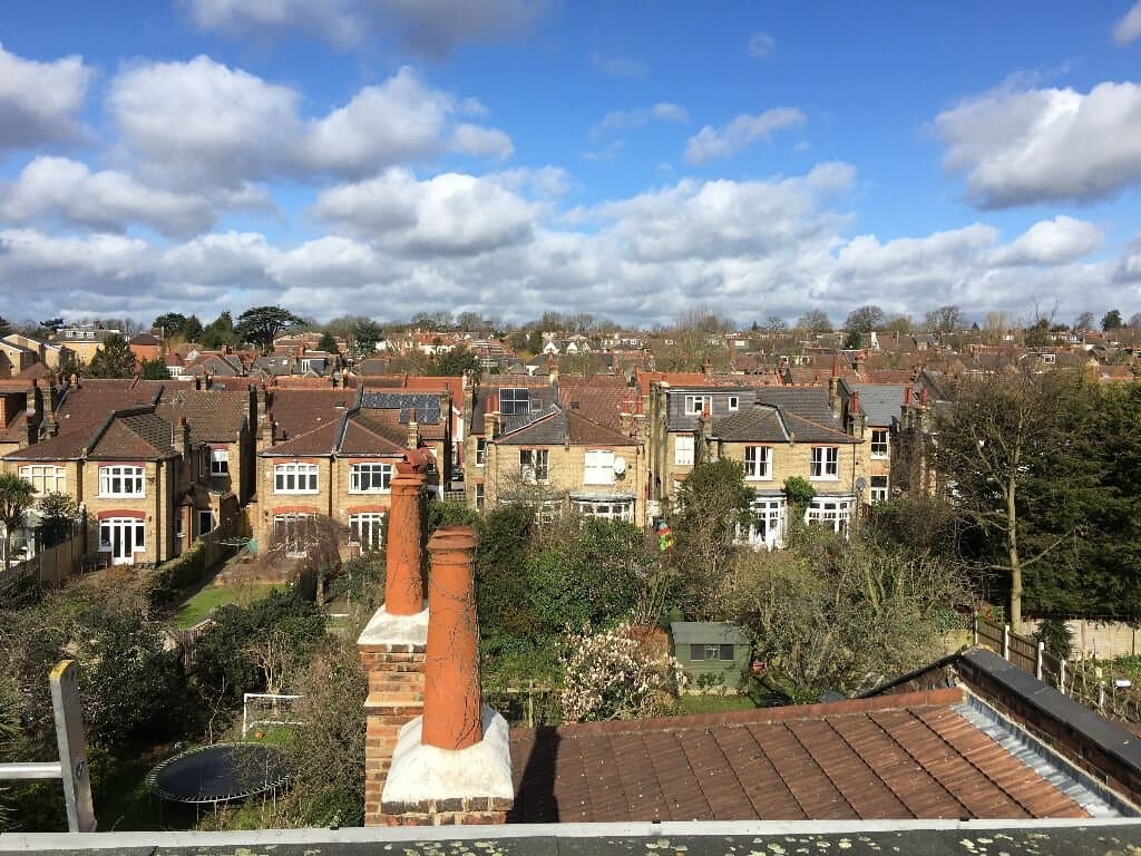 Completed chimney work against residential skyline