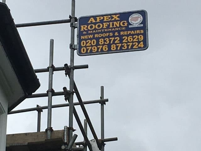 Branded scaffold sign at a roofing repair site