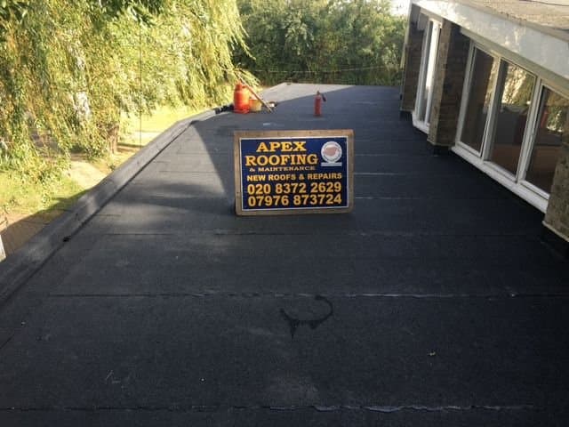 Apex roofing project sign on a completed roof area