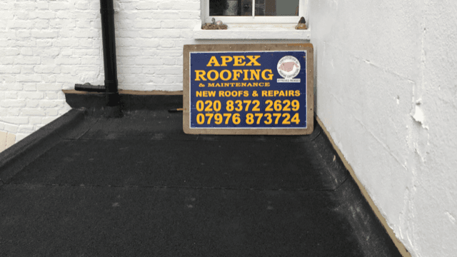 Project sign displayed on a roof after repairs